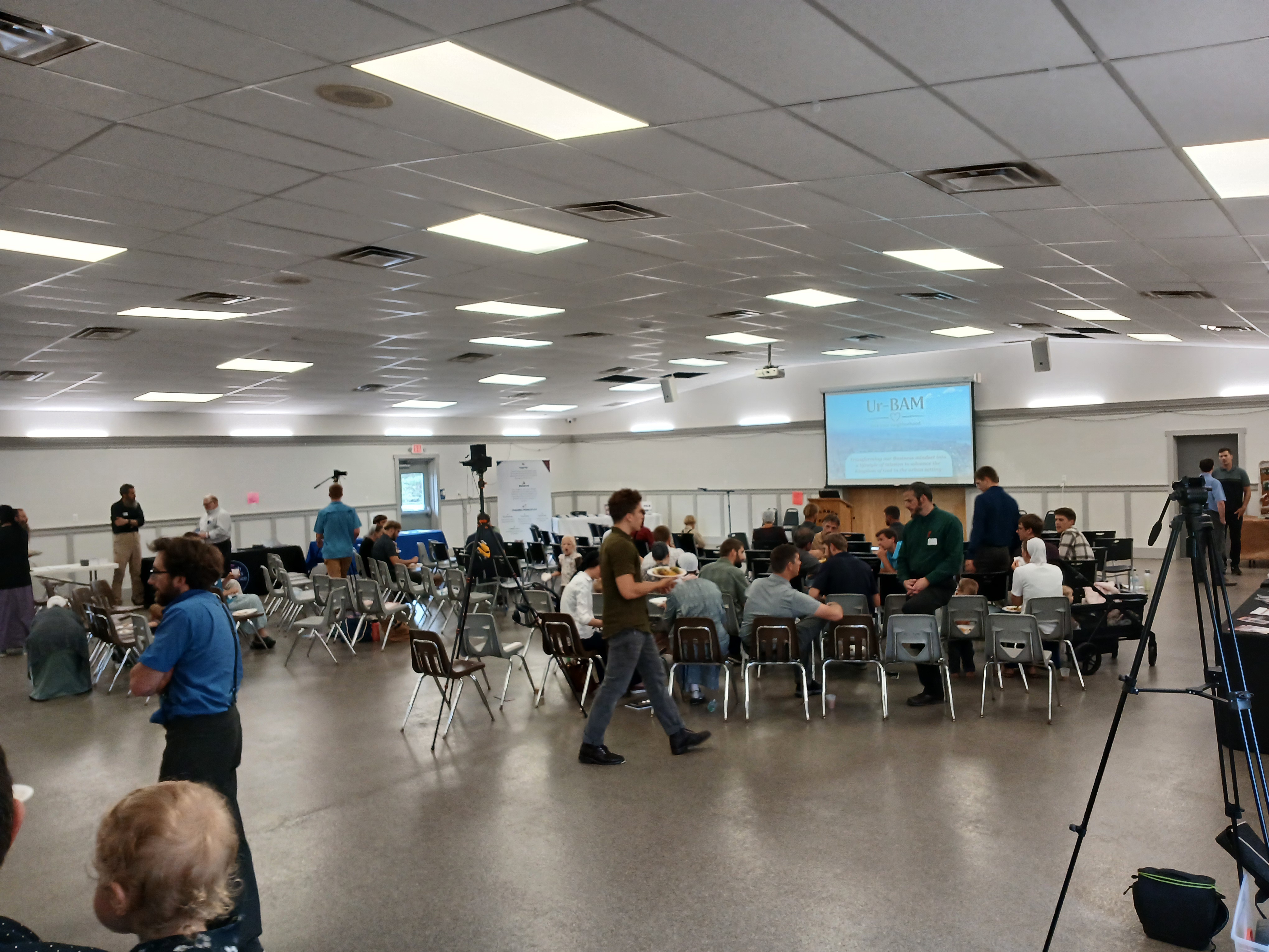 Ur-BAM Summit main session with attendees gathered around tables